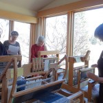 weavers working on looms at blockweave workshop